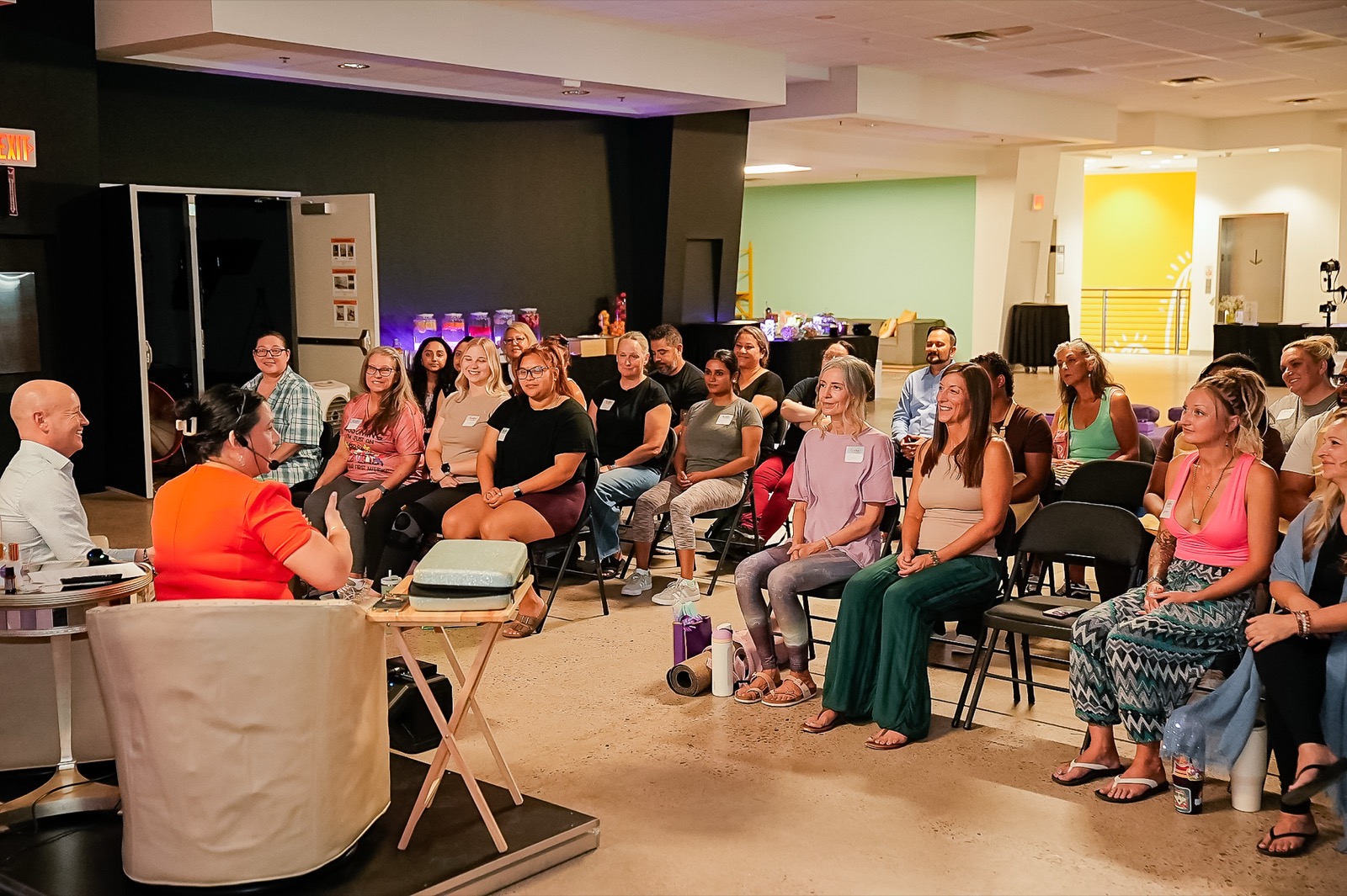 The view from behind the hosts: a lit-up, laughing audience