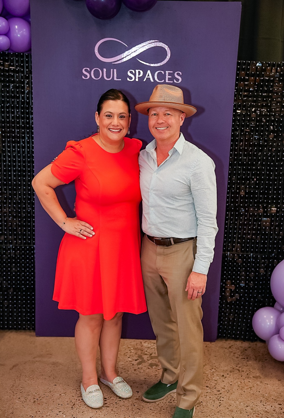 Teig and a co-facilitator at the branded backdrop